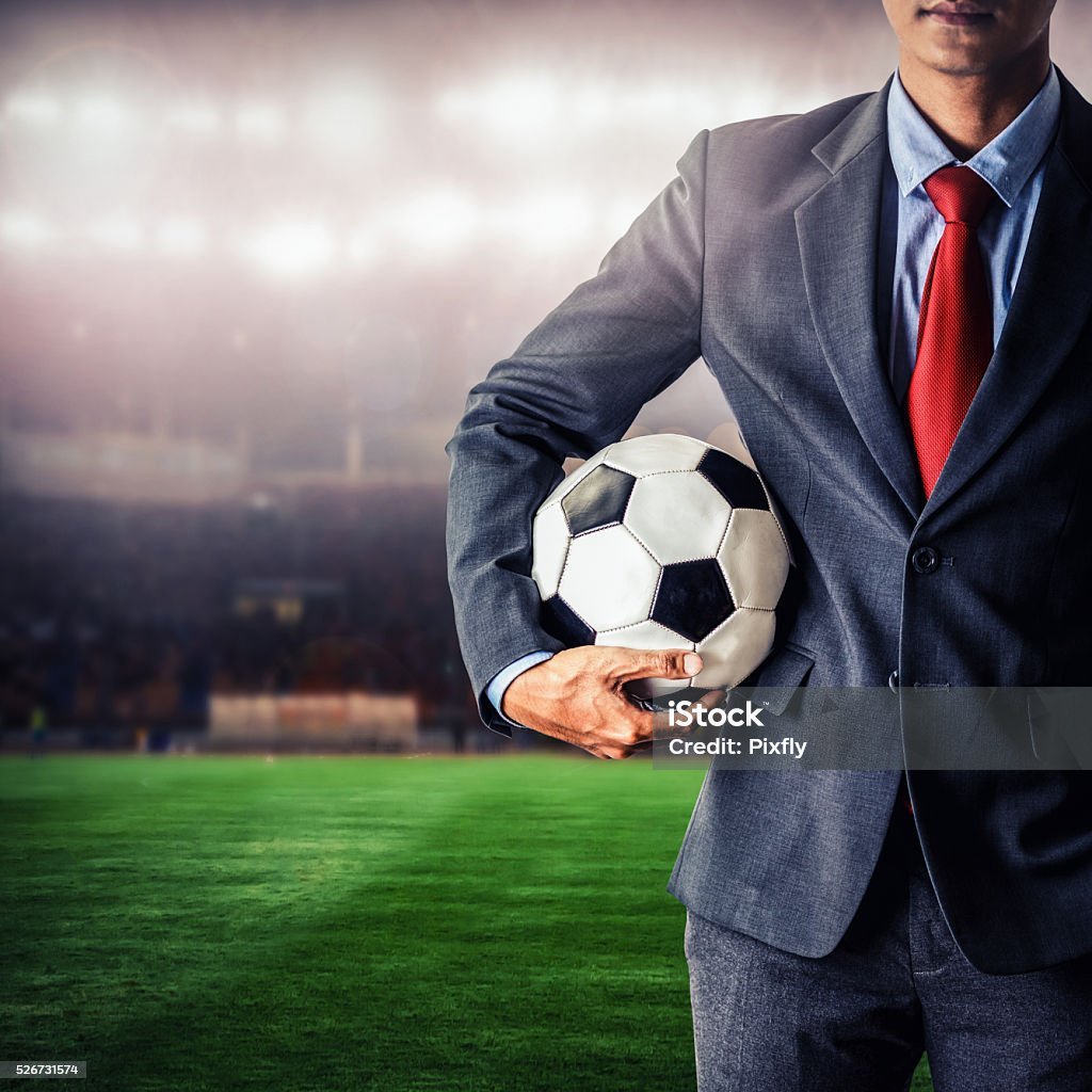 soccer manager holding football in the stadium,closeup color process